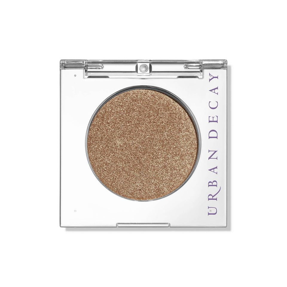 Urban Decay Half Baked front pan showing golden shimmer and secure packaging benefit