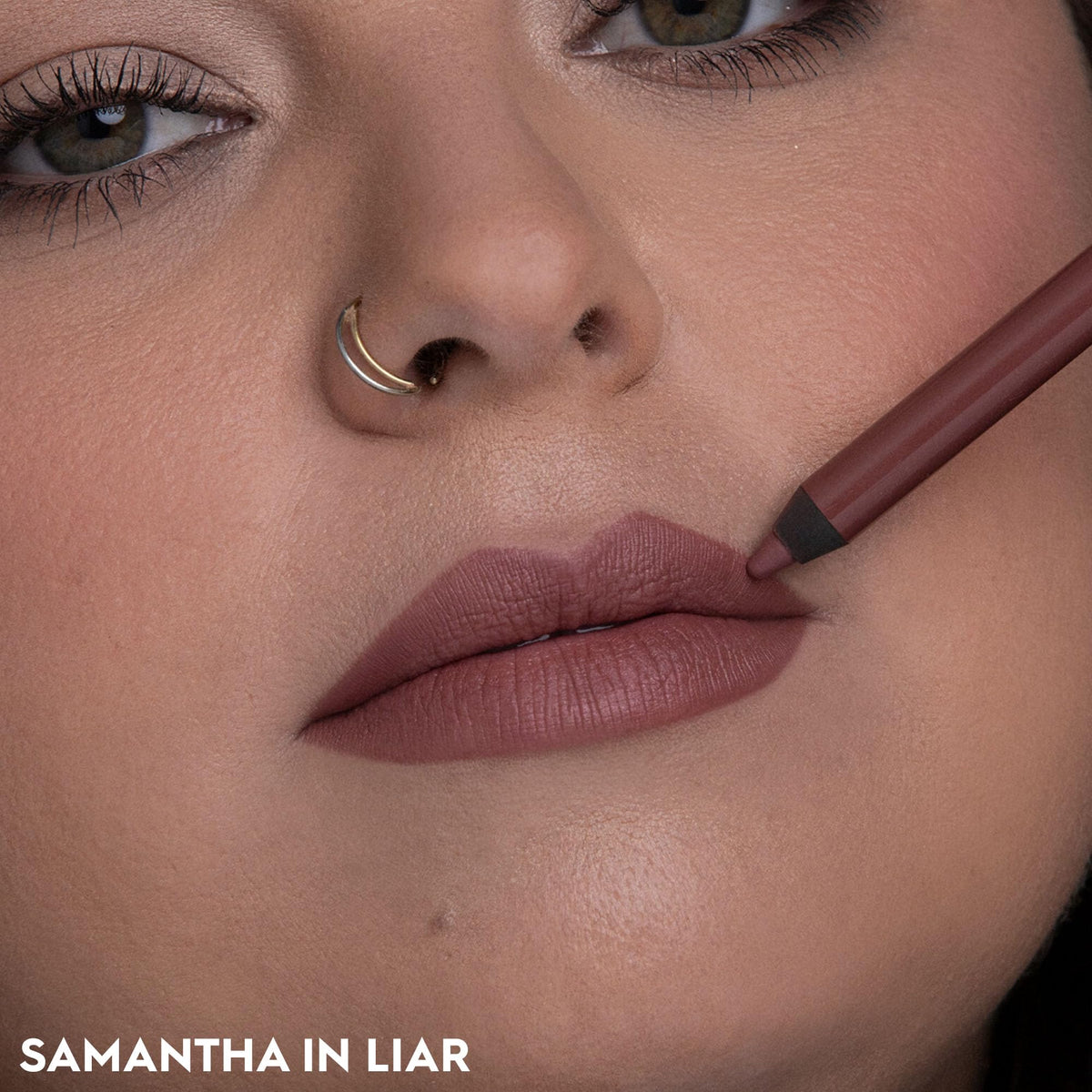 URBAN DECAY lips applied mauve nude demonstrating longwear definition and natural finish
