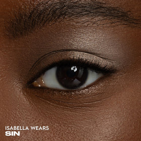 URBAN DECAY Sin swatch on skin highlighting champagne shimmer and high payoff