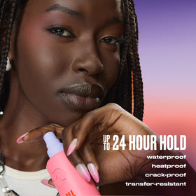 Urban Decay spray bottle in hand showing travel-friendly 1 fl oz convenience