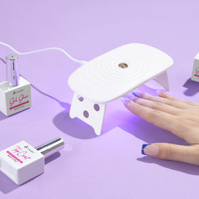 Vansiho assembled nails on hand demonstrating natural short square French look