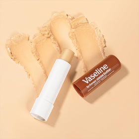 Hand holding Vaseline 10 oz bottle showing product size and portability