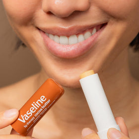 Vaseline cocoa butter balm on a nightstand suggesting overnight lip conditioning