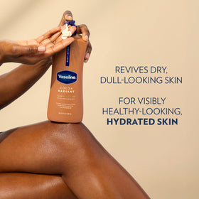 Vaseline bottle next to hand demonstrating 20.3 oz size and scale