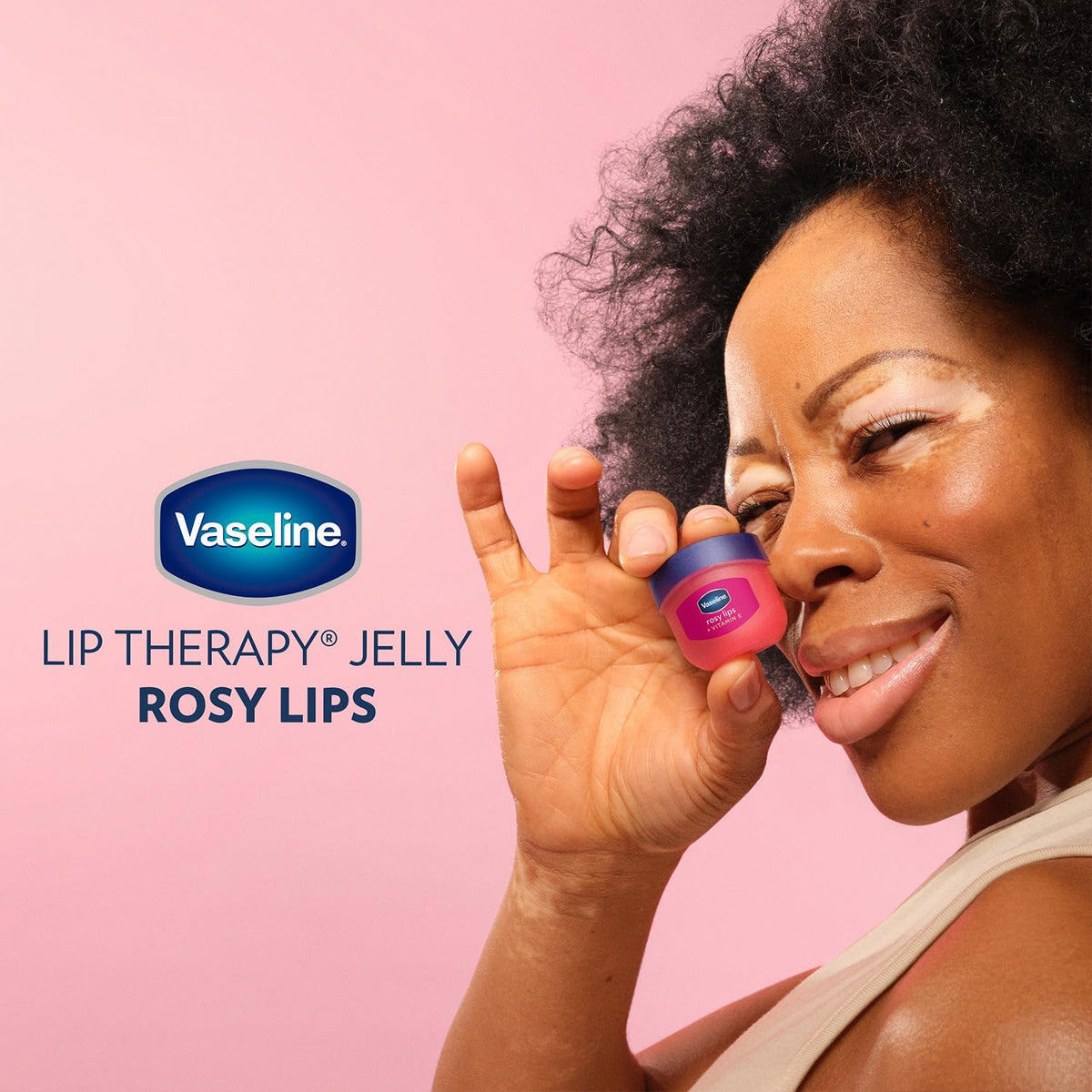 Person applying Vaseline outdoors demonstrating lip protection in windy conditions