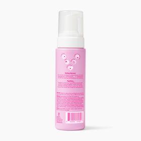 V&CO mousse on a bathroom shelf styled in a clean routine setting