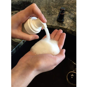 VEIDIA 2 oz bottle beside a measuring cup showing true travel size
