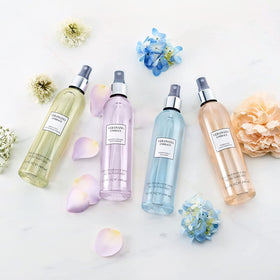 Vera Wang bottle on vanity with flowers illustrating daily routine and uplifting scent