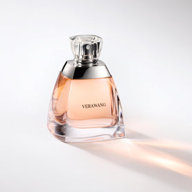 Vera Wang 3.4 fl oz bottle next to common items to show compact travel-friendly size