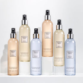 Vera Wang bottle held in hand illustrating 8 fl oz size and portability