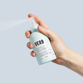 VERB mist spraying from bottle into hand for lightweight texture