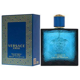 Versace Eros on a nightstand beside evening outfit suggesting confident aura