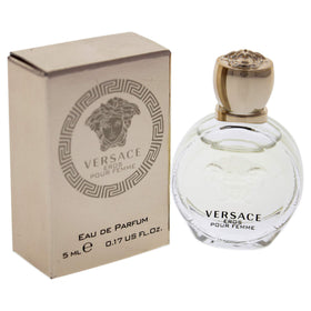 Versace bottle being splashed onto wrist for quick fragrance refresh