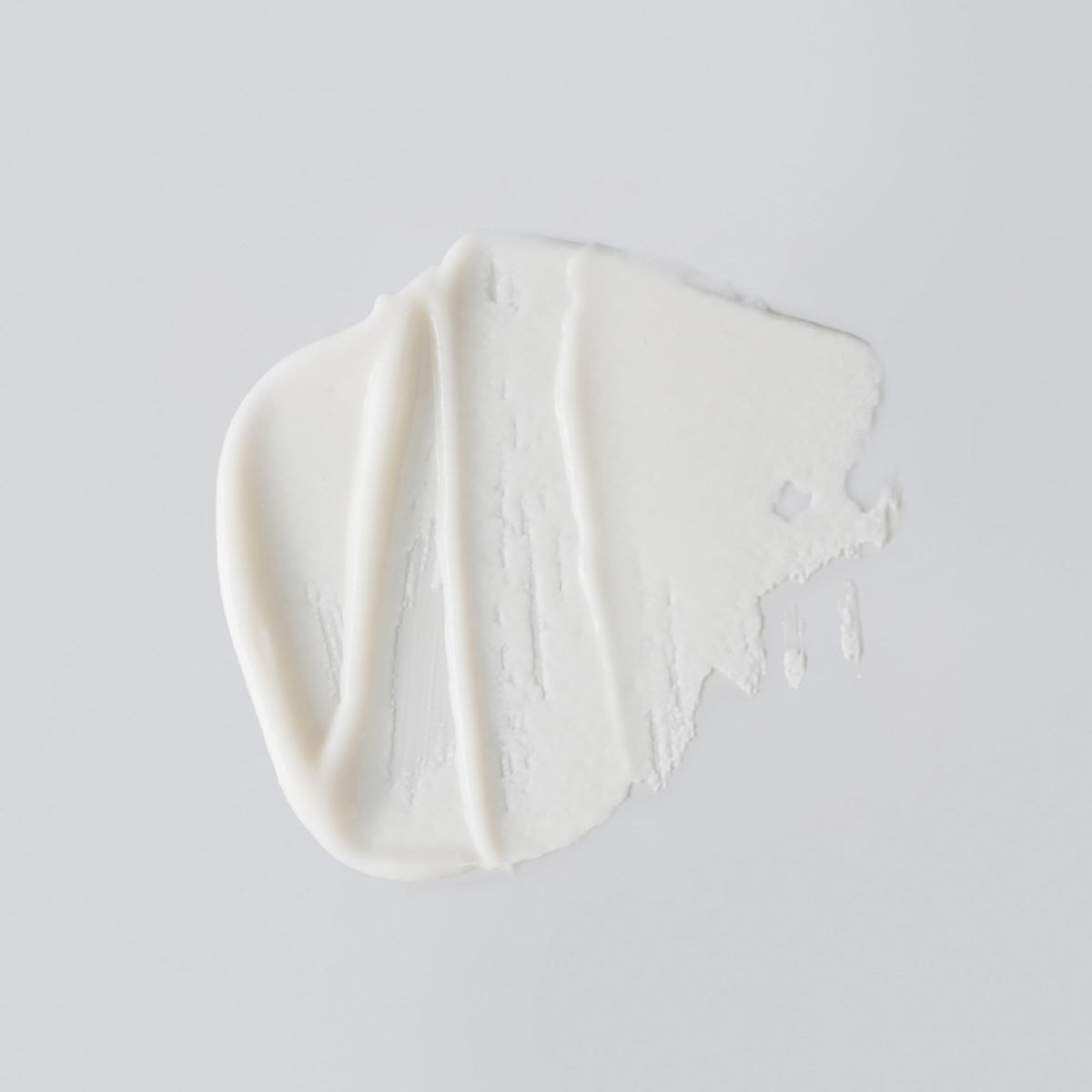 Versed pump dispensing creamy exfoliator, illustrates texture and ease of use for gentle exfoliation