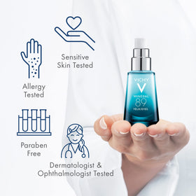 Vichy bottle in hand to show true size and travel-friendly benefit