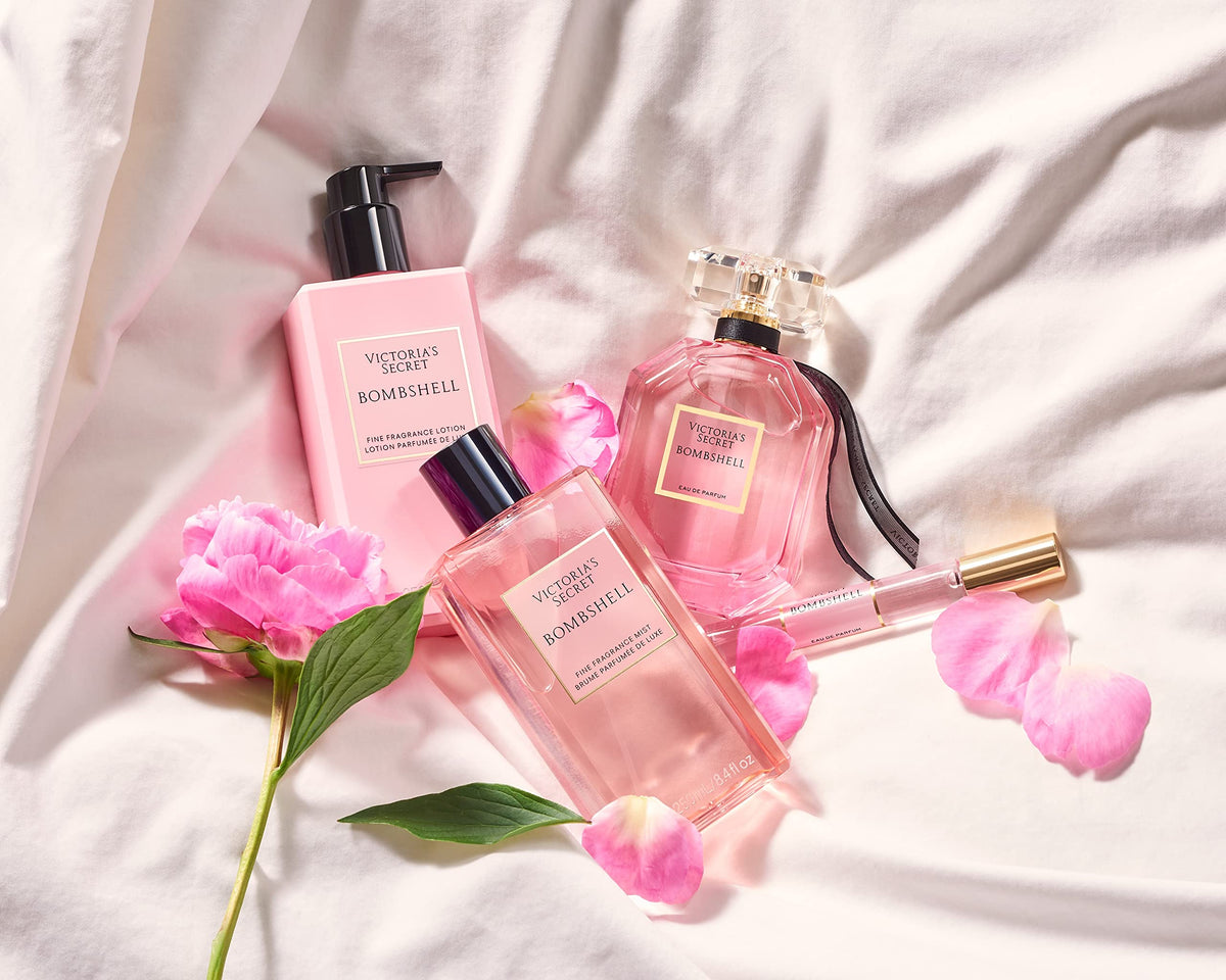 Victoria's Secret bottle held in hand for scale showing 8.4 oz portability benefit