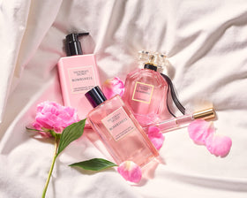 Victoria's Secret bottle held in hand for scale showing 8.4 oz portability benefit