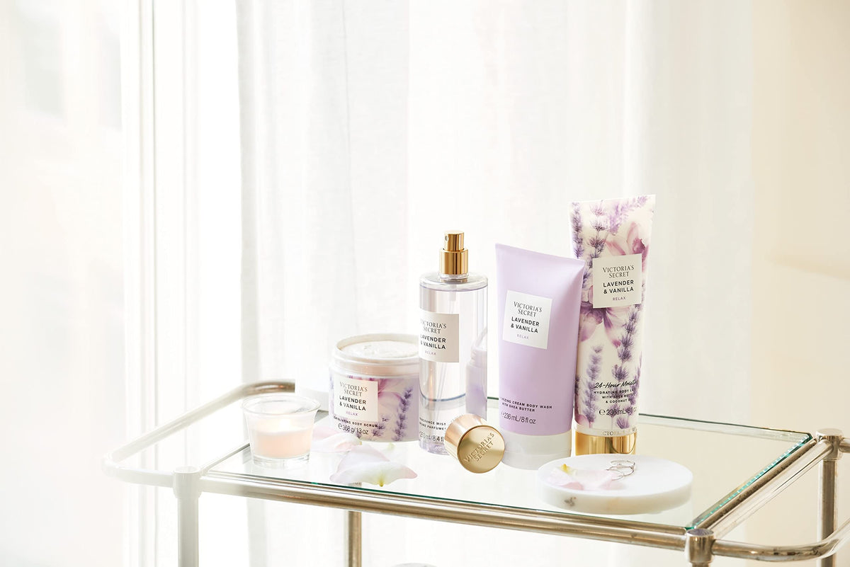Victoria's Secret bottle in hand to show 8 oz scale for travel convenience