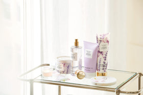 Victoria's Secret bottle in hand to show 8 oz scale for travel convenience