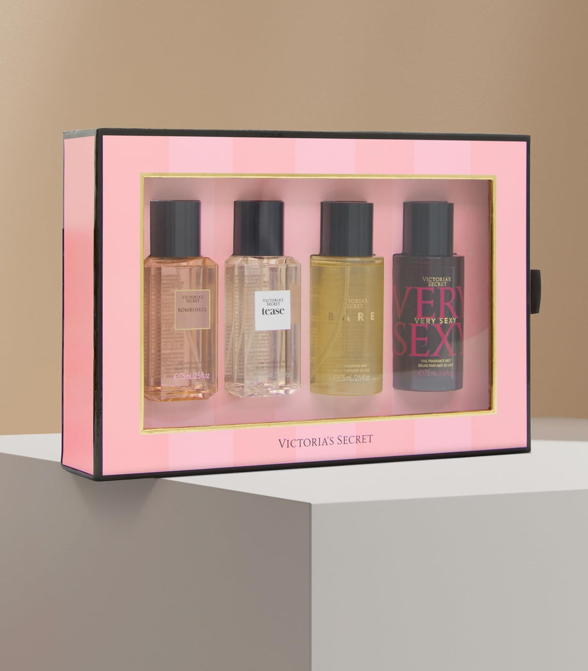 Victoria's Secret mini mists beside a smartphone to show compact travel-friendly size