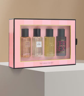 Victoria's Secret mini mists beside a smartphone to show compact travel-friendly size