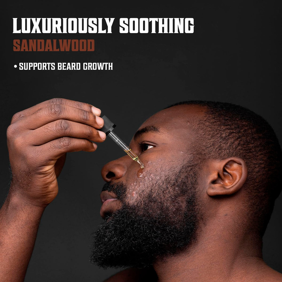 applying Viking Revolution beard oil with fingertips to soften and tame