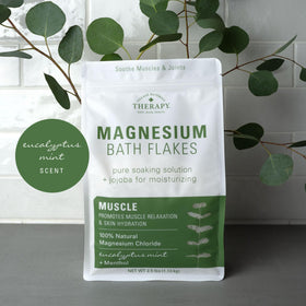 Village Naturals lifestyle bath scene with eucalyptus sprigs for relaxing soak