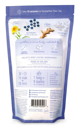 Village Naturals Therapy pouring foaming soak into tub for calming at-home spa benefit