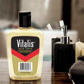 Vitalis close-up texture drop on fingers highlighting lightweight, non-greasy feel