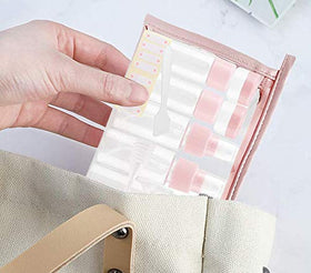 Vitog bottles next to a hand to show portable travel scale