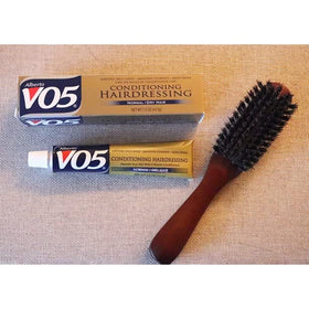 VO5 bottle next to travel items showing compact size for packing convenience