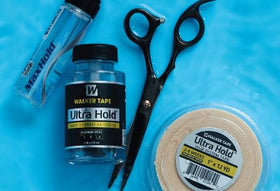 Walker Tape in use applying C-contour strip to hairpiece for secure hold
