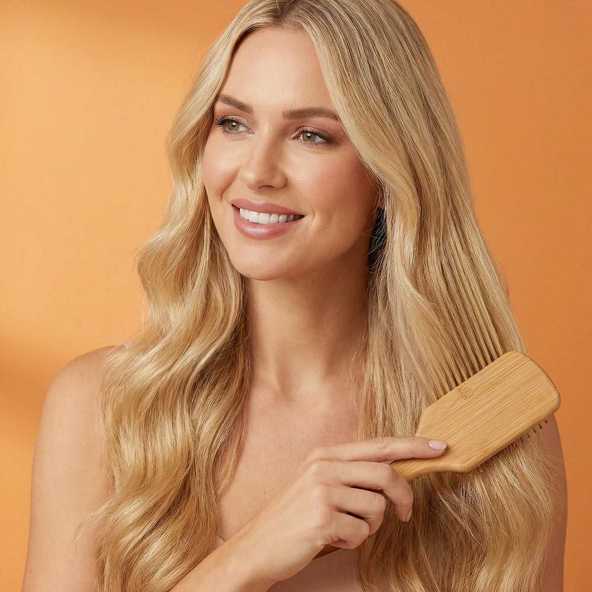 Wanmu brush held in hand to show scale and lightweight portability benefit