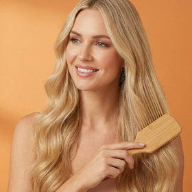 Wanmu brush held in hand to show scale and lightweight portability benefit