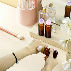 Warmify bottle held in hand illustrating 50ml travel-friendly size and convenience