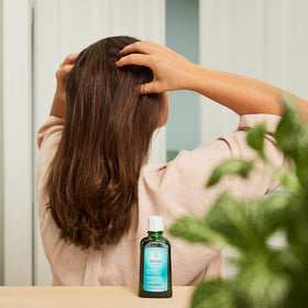 Weleda oil texture poured on hand illustrating smooth, non-greasy absorption benefit