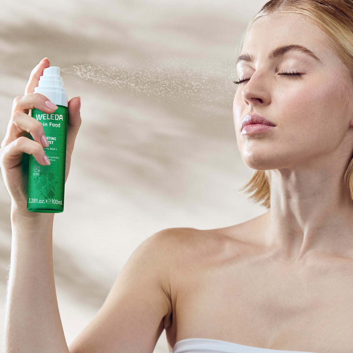 Weleda Skin Food held in hand to show travel-ready size and on-the-go hydration benefit