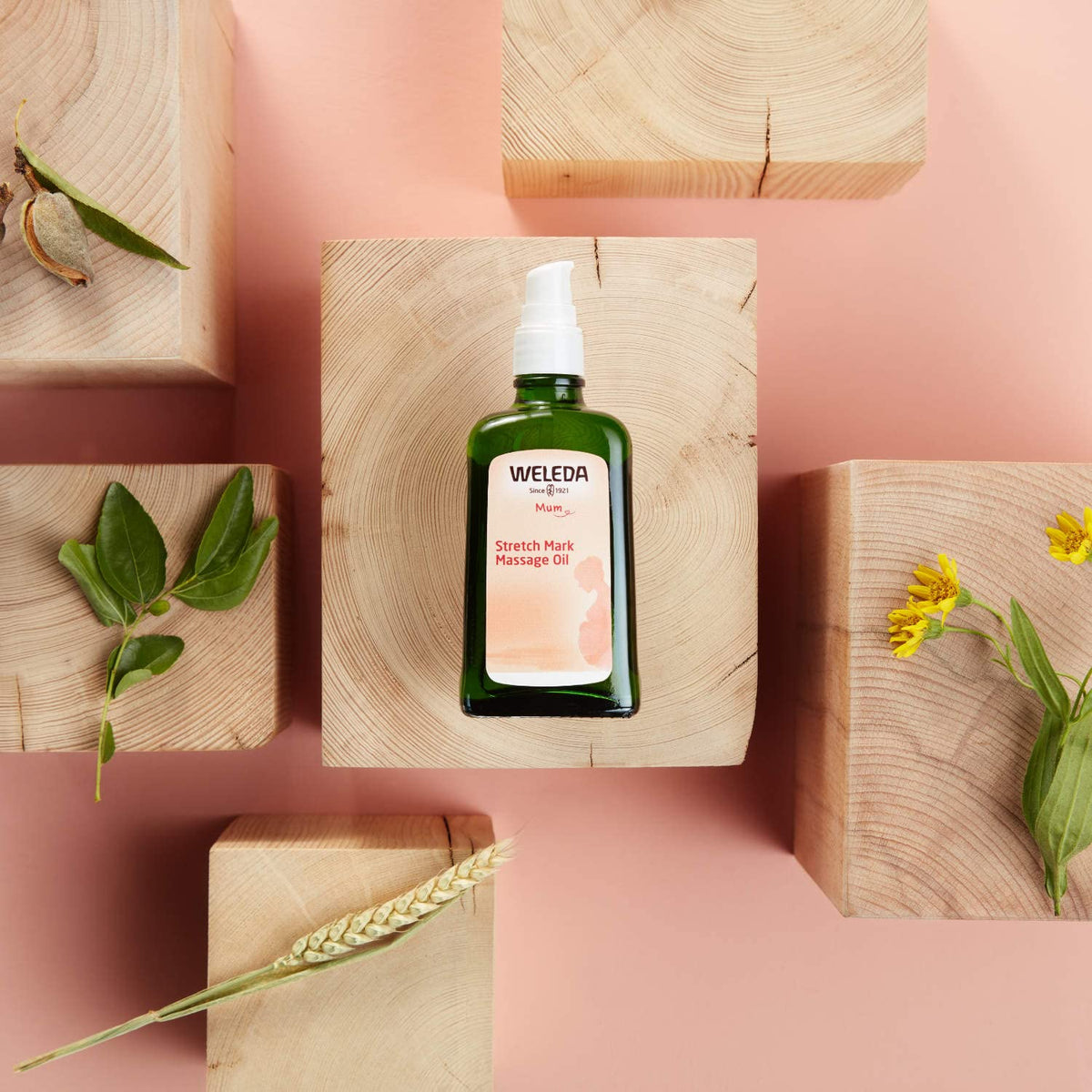 Weleda bottle held in hand to show 3.4 fl oz scale and easy handling