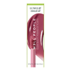 Well People lip oil next to lipstick to show compact size and layering option