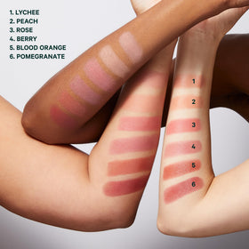 Well People swatch on arm showing berry color payoff and blendable texture