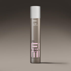 Wella Professionals EIMI Stay Firm next to ruler for scale showing 9 oz size benefit