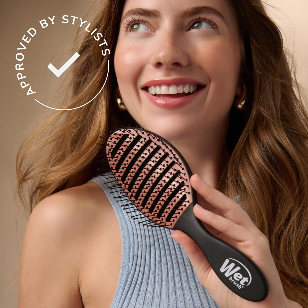 Wet Brush held next to a hand showing compact size and user-friendly scale