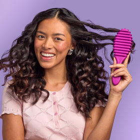Wet Brush packed in a gym bag to show travel-ready curl refreshing convenience