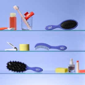 Wet Brush on bathroom counter near towel illustrating quick post-shower detangling