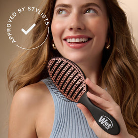 Wet Brush smoothing damp hair during blow-dry for faster styling results