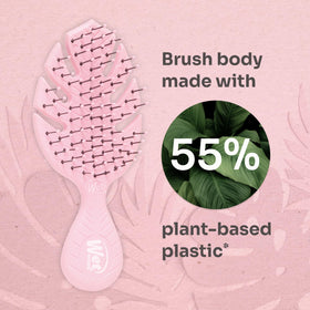 Wet Brush Go Green held in hand to show size and portability benefit