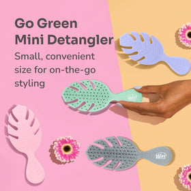 Wet Brush Go Green mini lifestyle travel scene in a purse for on-the-go touch-ups