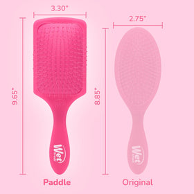 Wet Brush held in hand for scale to show paddle size and easier brushing