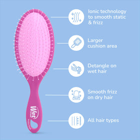 Wet Brush held in hand to show size and easy travel-friendly benefit