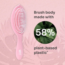 Wet Brush held in hand to show size and grip for easy on-the-go styling benefit